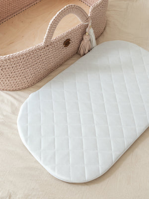 White mattress for a Moses basket with a hooded basket behind – Anzy Home